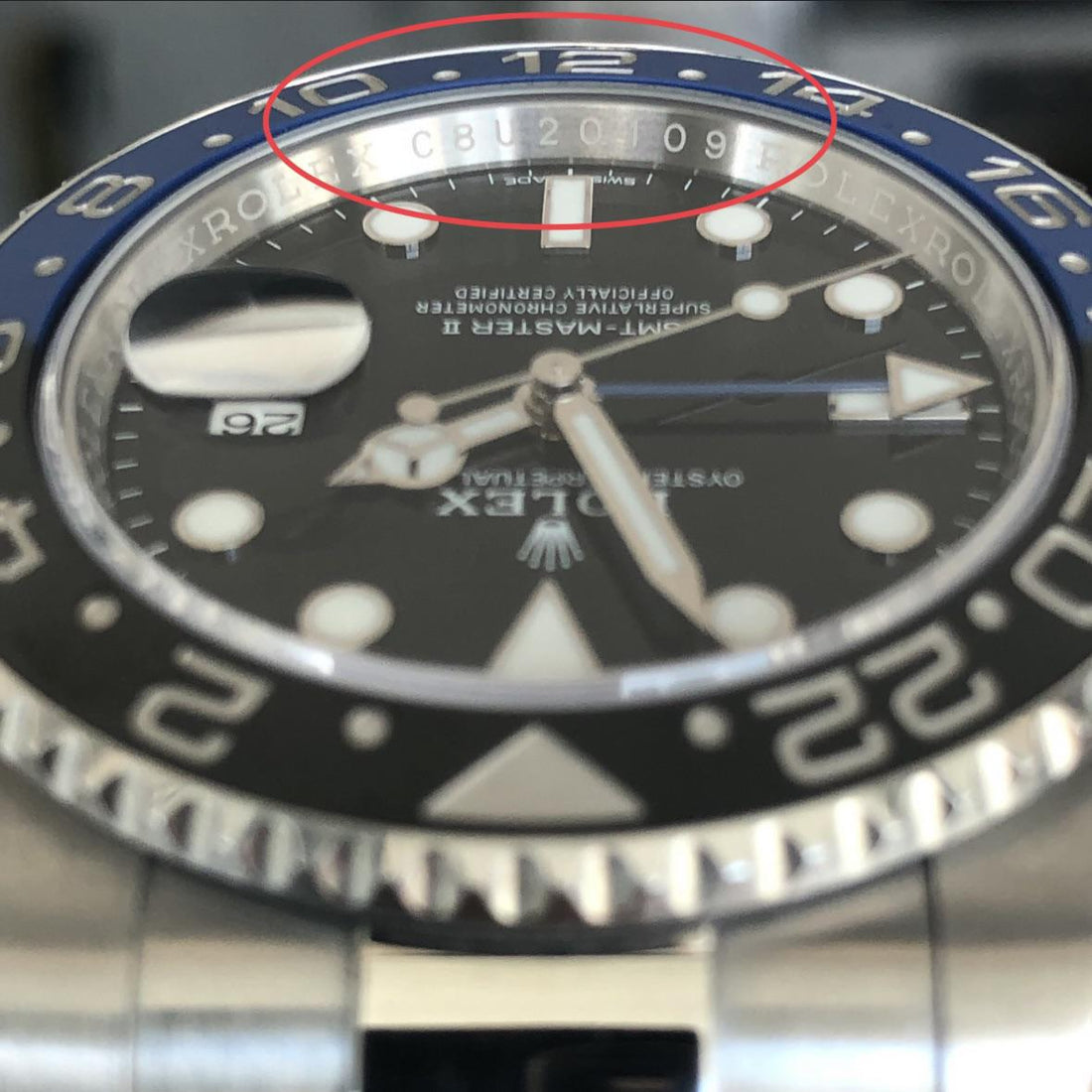 Rolex GMT-Master II Batman rehaut engraving showing random serial number CBU20109 circled - post-2010 random serial era