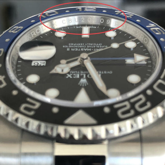 Rolex GMT-Master II Batman rehaut engraving showing random serial number CBU20109 circled - post-2010 random serial era